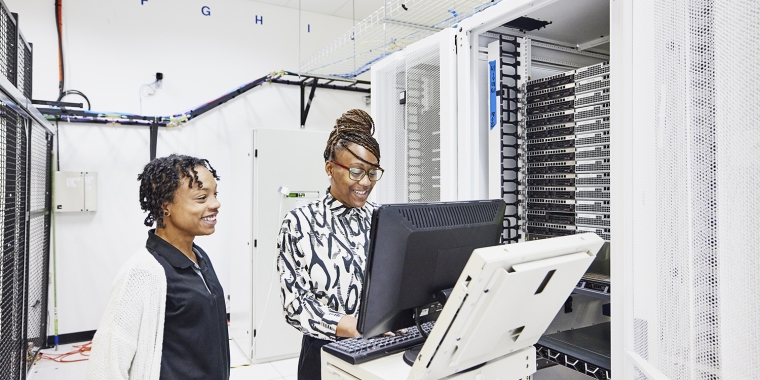 IT professionals in discussion while configuring server in data center